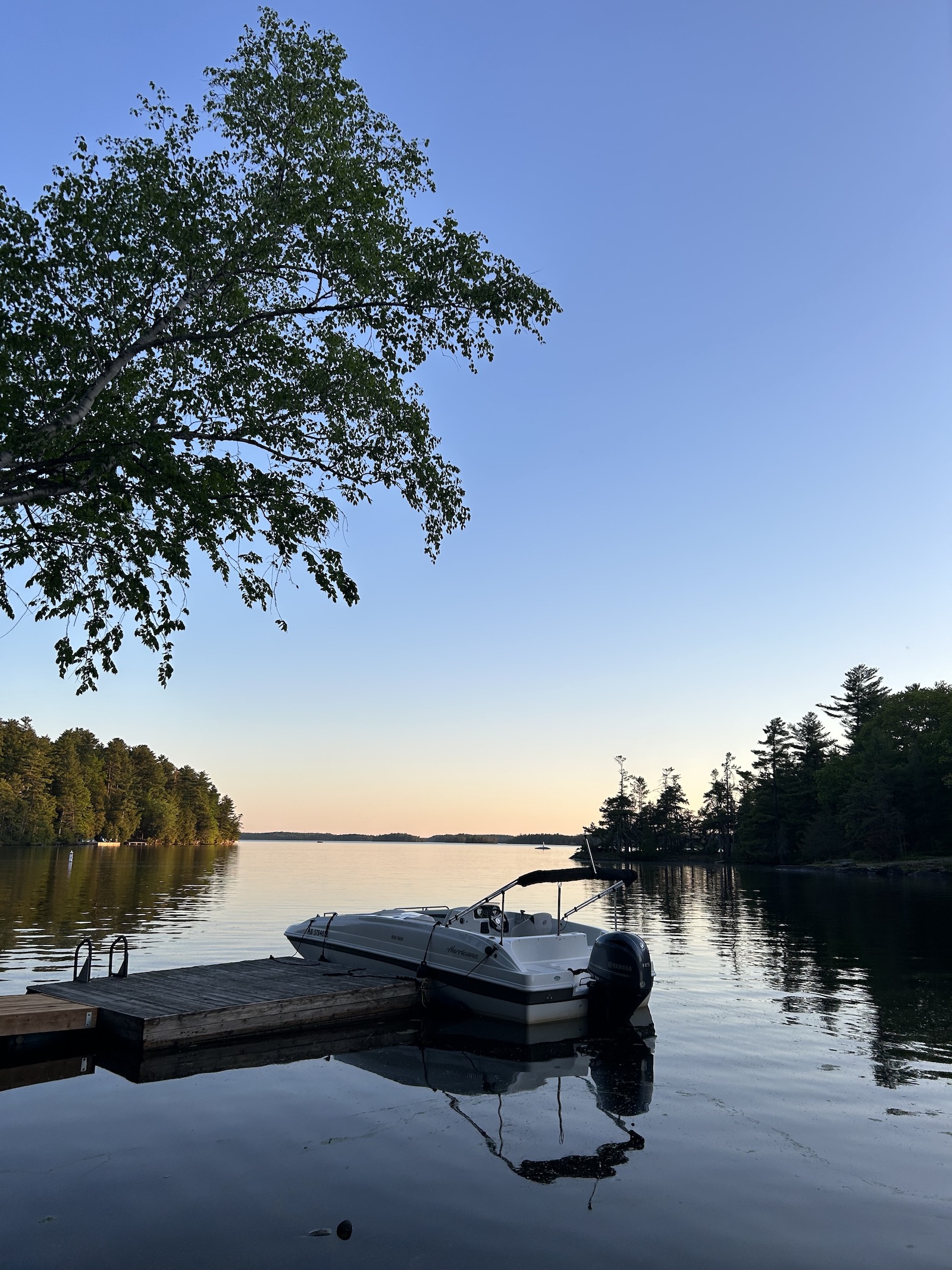 Floating dock and boat on Charleston Lake at sunset